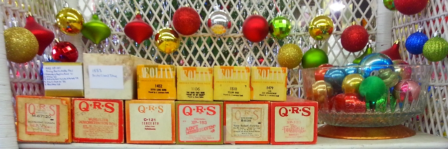 parlor lamps, electric lanterns, and oil lanterns lit with red indian silk with gold borders in the background